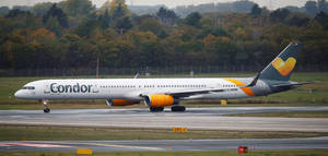 Condor Airlines Ariplane Taxiing On The Runway Wallpaper