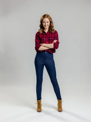 Confident Womanin Plaid Shirtand Jeans Wallpaper