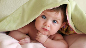 Cool Cute Baby Under Mattress Wallpaper