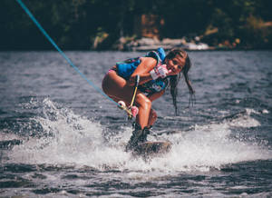 Cool Girl Ducked Wakeboarding Stance Wallpaper