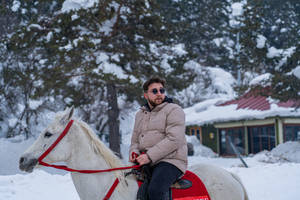 Cool Man Riding A Horse In Winter Wallpaper