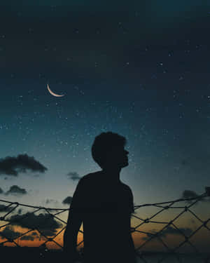 Cool Sad Boy During Starry Night Wallpaper