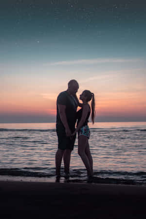 Couple At Beach Twilight Shot Wallpaper