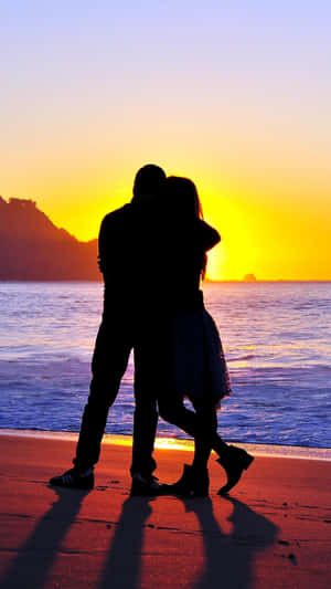 Couple Embrace Sunset Beach Wallpaper