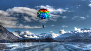 Couple Having Fun While Parasailing Wallpaper