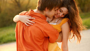 Couple In Orange Romantic Love Wallpaper