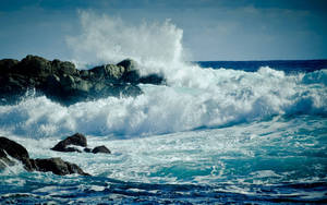 Crashing Wave On Rock Formation Wallpaper