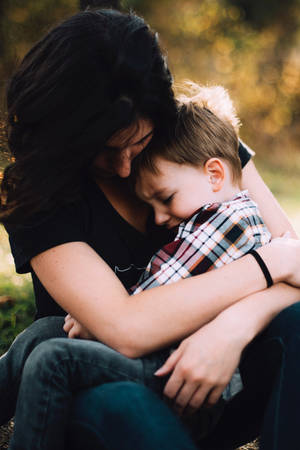 Crying Sad Boy With Mom Wallpaper