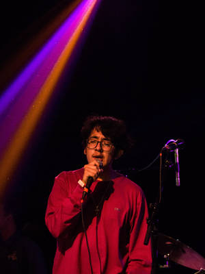 Cuco Holding A Microphone Wallpaper