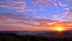 Cute And Cloudy Rural Sunset Wallpaper