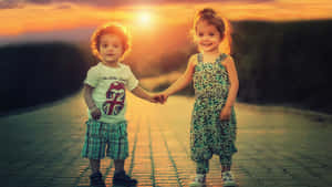 Cute Baby Couple Holding Hands Sunset Wallpaper