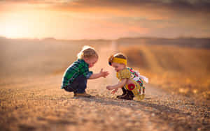 Cute Baby Couple Playing Sand Wallpaper