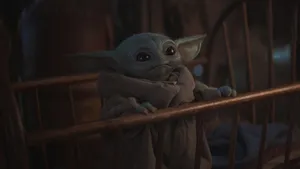 Cute Baby Yoda On Crib Wallpaper