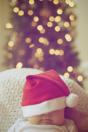 Cute Sleepy Baby Santa For Christmas Wallpaper