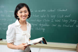 Cute Teacher On Blackboard Wallpaper