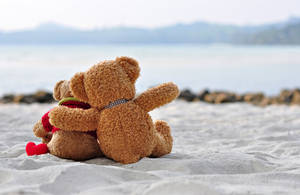 Cute Teddy Bear On The Sand Wallpaper