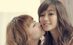 Cute Women Kissing Photo Wallpaper