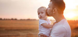 Dad Kissing Daughter Wallpaper