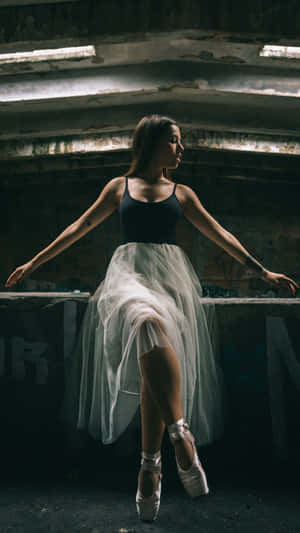 Dancing In Shadows: A Ballerina's Poise Wallpaper