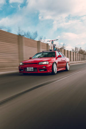 Dashing Red Nissan Skyline Gtr R34 Wallpaper