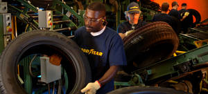 Dedicated Goodyear Workers On Assembly Line Wallpaper