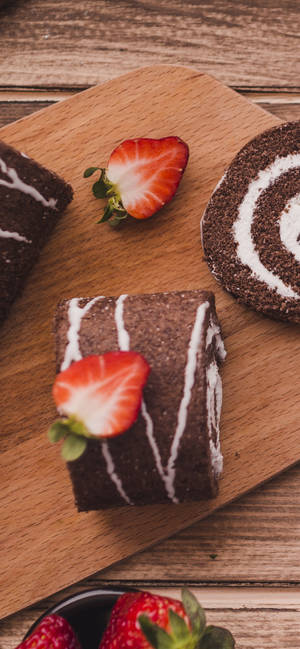 Delectable Chocolate Cake Roll Displayed On An Iphone 13 Pro Wallpaper