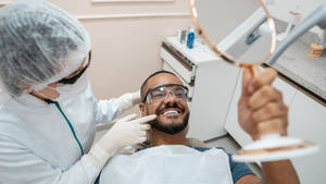 Dentist With Smiling Patient Wallpaper