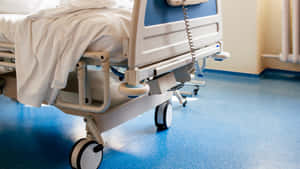 Detailed Close-up Of A Modern Hospital Bed With Wheels Wallpaper