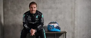 Determined Valtteri Bottas Sitting With His Racing Helmet Wallpaper