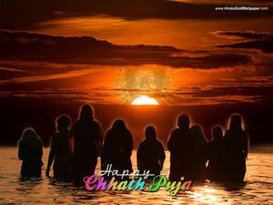 Devotees Celebrating Chhath Puja At Sunset Wallpaper
