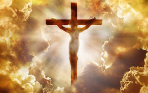 Divine Illumination: Jesus Christ On The Glowing Cross Wallpaper