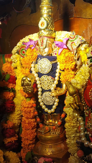 Divine Perception Of The Lord Balaji Golden Statue Wallpaper