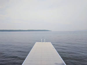 Dock At A Calming Lake Scenery Wallpaper