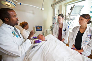 Doctors Surrounding Patient Wallpaper