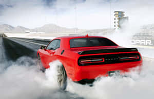 Dodge Challenger Srt - A Red Car Driving Down A Track Wallpaper