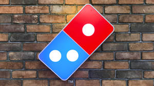 Dominos Pizza Logo On Brick Wall Wallpaper