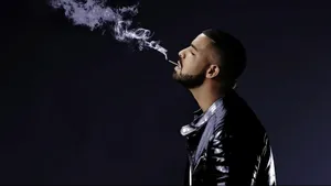 Drake Smokes A Cigarette In Black Leather Jacket Wallpaper