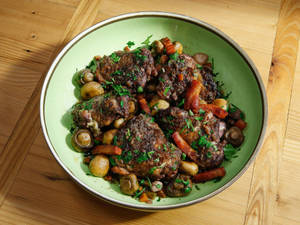 Dry Coq Au Vin Served On A Green Round Plate Wallpaper