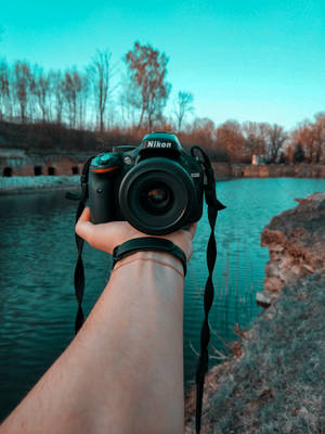 Dslr Camera At Arm's Length Wallpaper