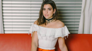 Dua Lipa 4k Posing Over White Blinds Wallpaper