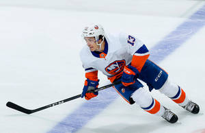 Dynamic Canadian Ice Hockey Star - Mathew Barzal In Action Wallpaper