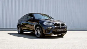 Dynamic Power Meets Luxury: A Sun-kissed Bmw X6 M Wallpaper