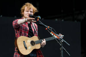 Ed Sheeran In Red Flannel Shirt Wallpaper
