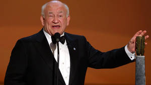 Edward Asner Delivering Iconic Speech Wallpaper