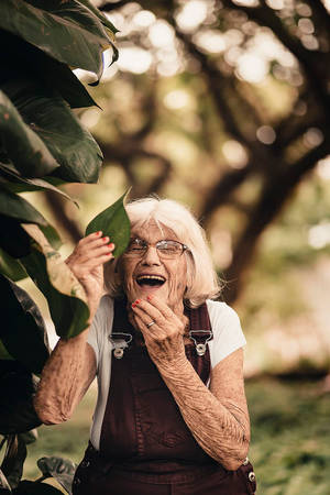 Elderly Woman With A Leaf Wallpaper