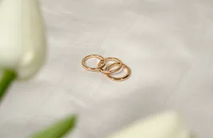 Elegance In Simplicity: Trio Of Rose Gold Rings Wallpaper