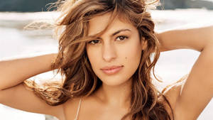 Elegant Eva Mendes Against A Hazy Backdrop Wallpaper