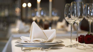 Elegant Table Setting In A High-end Restaurant Wallpaper