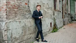 Elegant Young Man In Classy Black Suit Wallpaper