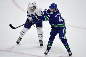 Elias Pettersson In Action Against Morgan Rielly Wallpaper